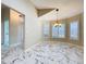 Open dining room featuring marble floors and plantation shutters at 1006 Sweet Jasmine Dr, Trinity, FL 34655