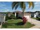 Well-maintained single-story home featuring lush landscaping, an attached two-car garage, and a welcoming front entrance at 1006 Sweet Jasmine Dr, Trinity, FL 34655