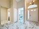 Bright foyer showcasing tile floors, a laundry room, and an open view into the adjacent living spaces at 1006 Sweet Jasmine Dr, Trinity, FL 34655