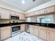 Open kitchen featuring granite countertops and stainless steel appliances at 1006 Sweet Jasmine Dr, Trinity, FL 34655