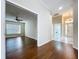 Open-concept living room with hardwood flooring and an inviting view into the adjacent entryway and laundry at 1006 Sweet Jasmine Dr, Trinity, FL 34655
