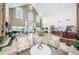 Bright lobby features high ceilings, large windows, fireplace, and sitting area near the reception desk at 1006 Sweet Jasmine Dr, Trinity, FL 34655