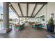 Covered patio with several tables and chairs adjacent to a pool at 1006 Sweet Jasmine Dr, Trinity, FL 34655