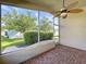 Inviting screened porch with brick pavers and a view of landscaped backyard at 1006 Sweet Jasmine Dr, Trinity, FL 34655