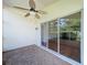 Screened porch with brick flooring and a ceiling fan at 1006 Sweet Jasmine Dr, Trinity, FL 34655