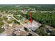 Aerial view showing the home in relation to surrounding neighborhood and wooded areas at 10228 Beechcraft St, New Port Richey, FL 34654