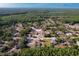Aerial view of neighborhood, showing wooded areas, ponds, homes, and roadways on a sunny day at 10228 Beechcraft St, New Port Richey, FL 34654