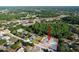 Aerial view showing the home in relation to surrounding neighborhood and wooded areas at 10228 Beechcraft St, New Port Richey, FL 34654