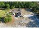 Aerial view of a house with a screened pool, driveway, and treed landscaping on a spacious lot at 10228 Beechcraft St, New Port Richey, FL 34654