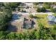 Aerial view of a beautiful home featuring a screened pool and lush landscaping at 10228 Beechcraft St, New Port Richey, FL 34654