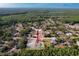 Aerial view showing the home in relation to surrounding neighborhood and wooded areas at 10228 Beechcraft St, New Port Richey, FL 34654