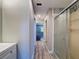 Hallway bathroom featuring a vanity with shower visible in the mirror at 10228 Beechcraft St, New Port Richey, FL 34654