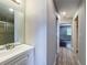 Bathroom with white vanity and a shower that is visible from the doorway at 10228 Beechcraft St, New Port Richey, FL 34654