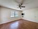 Bedroom featuring hardwood floors, a ceiling fan, and one window with blinds at 10228 Beechcraft St, New Port Richey, FL 34654
