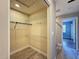 Open closet features wire shelves, wood look floors, and access to a shower and bedroom with natural light at 10228 Beechcraft St, New Port Richey, FL 34654