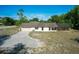 Wide angle of a single-story home with attached two-car garage and screened-in lanai at 10228 Beechcraft St, New Port Richey, FL 34654