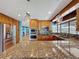 Spacious kitchen with stainless steel appliances and granite island overlooking living area at 10228 Beechcraft St, New Port Richey, FL 34654