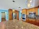The open-concept kitchen features granite countertops and stainless steel appliances at 10228 Beechcraft St, New Port Richey, FL 34654