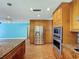 Gourmet kitchen with granite island, stainless steel appliances, and hardwood floors at 10228 Beechcraft St, New Port Richey, FL 34654