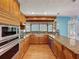 Bright kitchen with stainless steel appliances, granite countertops, and hardwood flooring at 10228 Beechcraft St, New Port Richey, FL 34654