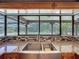 Stainless steel kitchen sink with mosaic backsplash, granite countertops, and pool views at 10228 Beechcraft St, New Port Richey, FL 34654