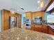Modern kitchen featuring stainless steel appliances and a large granite-topped island at 10228 Beechcraft St, New Port Richey, FL 34654