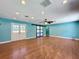 Spacious living room boasts wood-look flooring, recessed lights, and a sliding barn door at 10228 Beechcraft St, New Port Richey, FL 34654