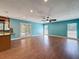 Living room with hard wood floors and ceiling fan and view to the back yard at 10228 Beechcraft St, New Port Richey, FL 34654