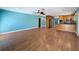 View of living room with hard wood floors, view to the kitchen, stainless steel appliances and updated kitchen at 10228 Beechcraft St, New Port Richey, FL 34654