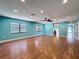 Bright living room boasts wood-look tile floors, recessed lighting, and large windows at 10228 Beechcraft St, New Port Richey, FL 34654