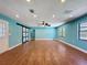 Bright living room features wood-look flooring, recessed lighting, a ceiling fan and sliding barn door at 10228 Beechcraft St, New Port Richey, FL 34654