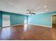 Living room with hardwood floors, ceiling fan and lots of windows at 10228 Beechcraft St, New Port Richey, FL 34654