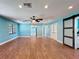 Bright living room boasts wood-look tile floors, recessed lighting, and sliding barn doors at 10228 Beechcraft St, New Port Richey, FL 34654