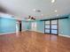 Spacious living room features wood-look flooring, ceiling fan, and sliding barn doors at 10228 Beechcraft St, New Port Richey, FL 34654