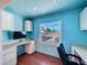 Well-lit office space featuring built-in desks, ample storage, and a large window with natural light at 10228 Beechcraft St, New Port Richey, FL 34654
