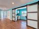 Bright office area with built-in desk and storage, separated by sliding barn doors and wood-look tile flooring at 10228 Beechcraft St, New Port Richey, FL 34654