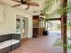 Covered patio featuring tile flooring, tropical plants, and an outdoor kitchen area, perfect for entertaining at 10228 Beechcraft St, New Port Richey, FL 34654