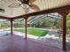 Enclosed pool area with a covered patio, tropical plants, and privacy screen, perfect for outdoor relaxation at 10228 Beechcraft St, New Port Richey, FL 34654