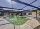 Backyard pool with an expansive screen enclosure, patio area, and easy access to the home's interior spaces at 10228 Beechcraft St, New Port Richey, FL 34654