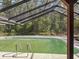 A beautiful enclosed backyard pool surrounded by lush greenery and trees, providing a serene retreat at 10228 Beechcraft St, New Port Richey, FL 34654