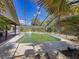 Inviting backyard pool is surrounded by a screened enclosure and mature landscaping providing privacy and a great view at 10228 Beechcraft St, New Port Richey, FL 34654