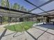 Backyard view of the pool is surrounded by a full screen enclosure, pool-side patio, and outdoor living space at 10228 Beechcraft St, New Port Richey, FL 34654