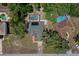 Overhead shot of the home featuring a screened pool, solar panels and a well-kept yard at 11353 Norvell Rd, Spring Hill, FL 34608