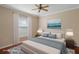 Staged bedroom with ceiling fan, neutral walls, and window providing natural light at 11353 Norvell Rd, Spring Hill, FL 34608