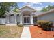 Inviting front entrance with decorative double doors, columns, and tidy landscaping details at 11353 Norvell Rd, Spring Hill, FL 34608