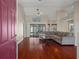 Open living room featuring high ceilings, hardwood floors, and a view of the screened-in pool at 11353 Norvell Rd, Spring Hill, FL 34608