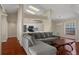 Open layout showcasing the living room flowing seamlessly into the kitchen area with hardwood floors at 11353 Norvell Rd, Spring Hill, FL 34608