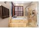 This spacious bathroom offers a jacuzzi tub and a glass shower at 12040 Penzance Ln, New Port Richey, FL 34654