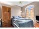 This comfortable bedroom features a ceiling fan, closet, and a large window at 12040 Penzance Ln, New Port Richey, FL 34654