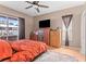 This comfortable bedroom features a ceiling fan, closet, and a large window at 12040 Penzance Ln, New Port Richey, FL 34654